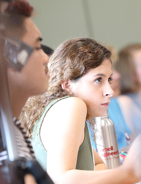 A female student watches a presenter during the CATALYST sustainability sessions